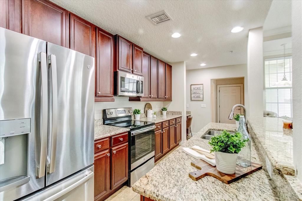 Kitchen with granite counter tops and great cabinet storage.