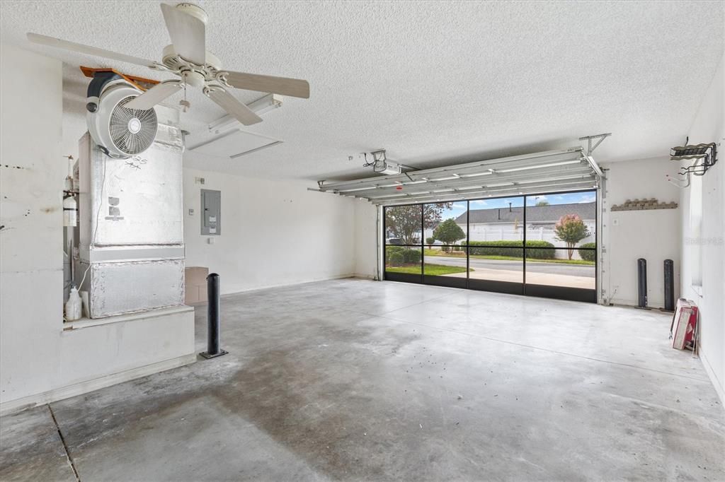 FANTASTIC SPACIOUS GARAGE WITH GARAGE DOOR SCREEN AND ROOM FOR LONGER VEHICLE OR TWO GOLF CARTS