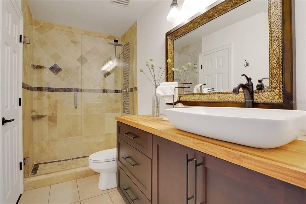 Guest bathroom that adjoins to guest bedroom and provides access to main living space.