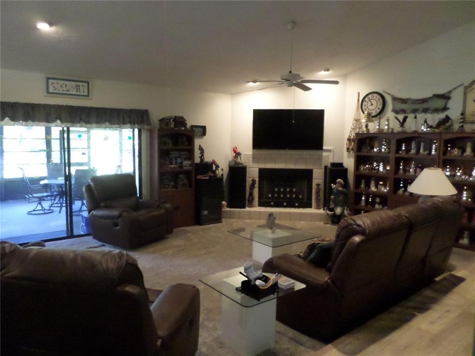 LIVING ROOM FIREPLACE,MOUNTED TV OVER FIREPLACE INCLUDED  SLIDING DOORS TO SCREENED PORCH