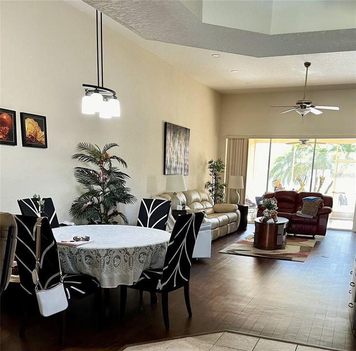 Large formal dining area and living room combination with high vaulted ceiling.