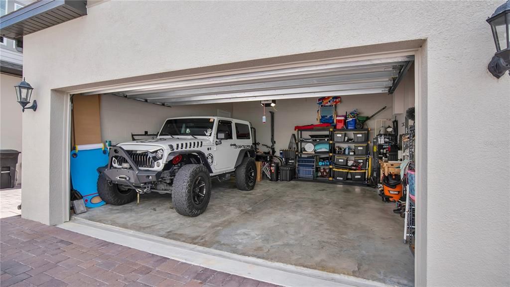 EXTERIOR LOOKING INTO OVERSIZED GARAGE WITH STORAGE RACKS