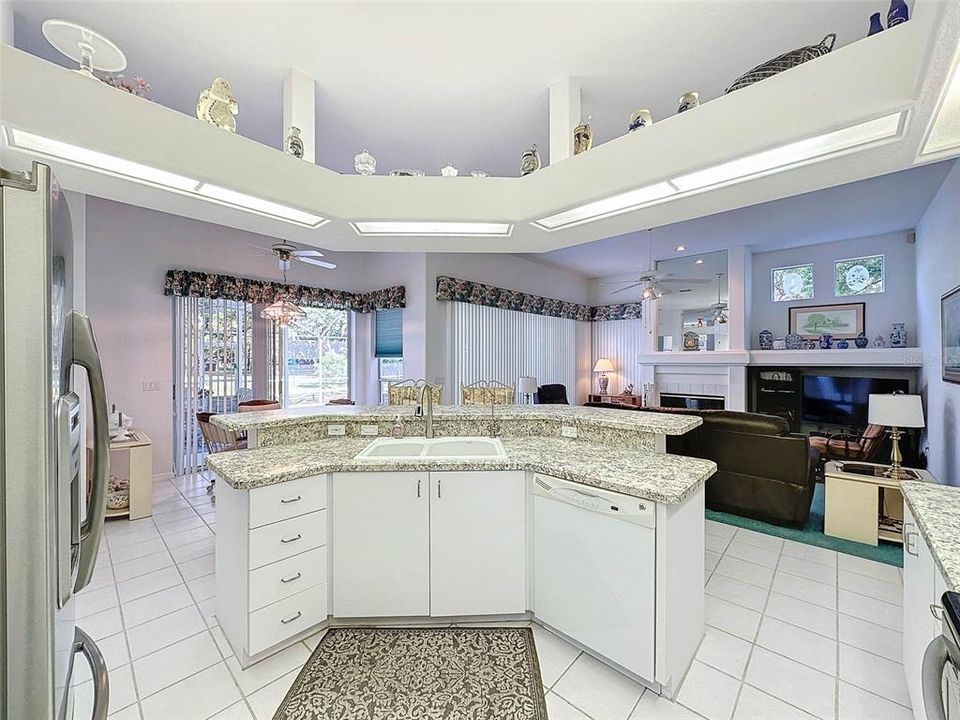 Kitchen Island looks out Family Room & Pool