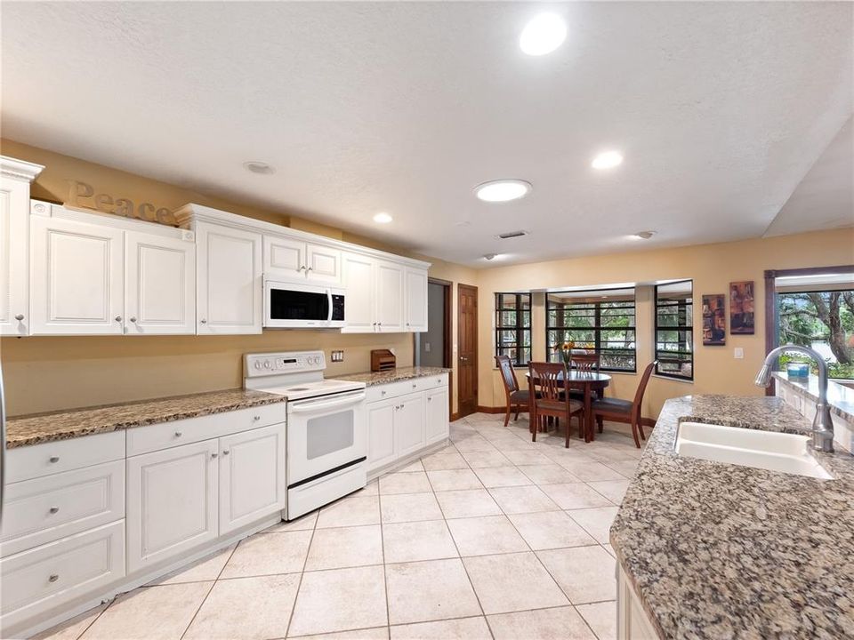 Kitchen with tile floors and granite countertops.