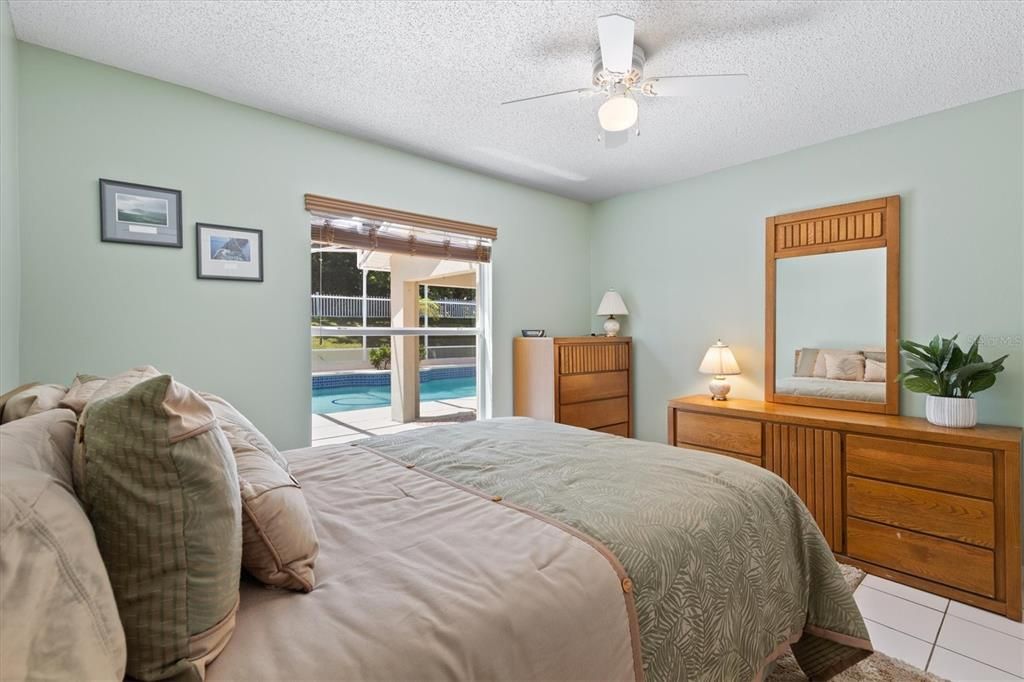 Second bedroom with view of pool