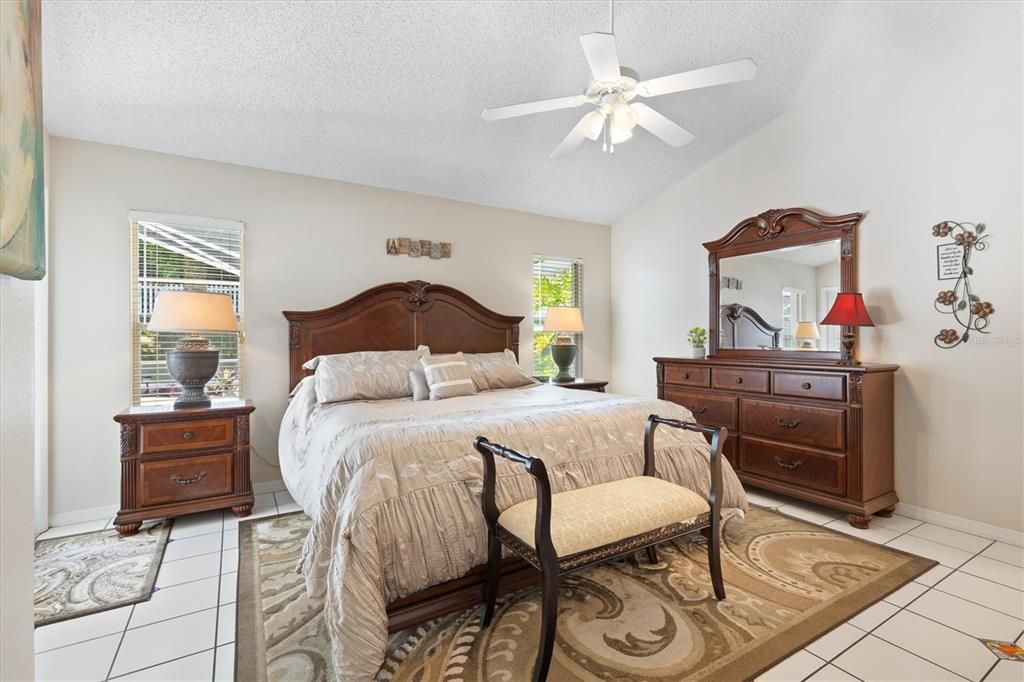 Master bedroom offers plenty of natural light with French door leading out to covered enclosed pool