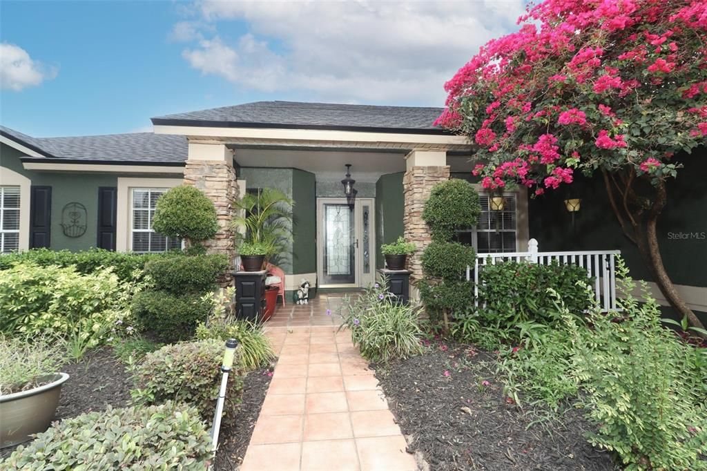 Neat, clean, pretty front to welcome you in.  Spacious front porch to enjoy the garden.