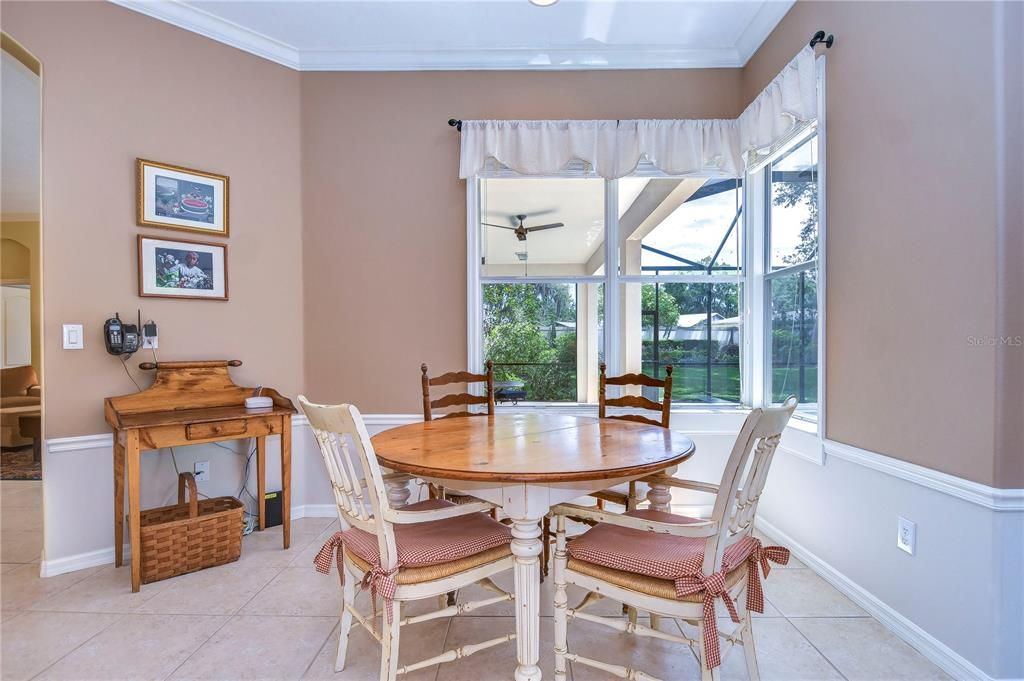 Bright breakfast nook that has a large corner window with a view of the pool!