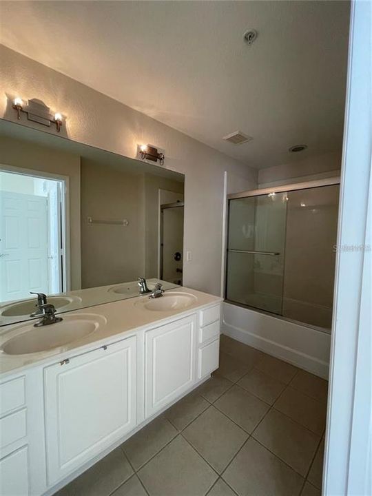 Master bathroom offers a private bathroom with dual sinks and a shower/tub combo.