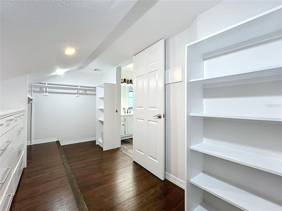 Walk in closet in bedroom 3 with built in shelves.