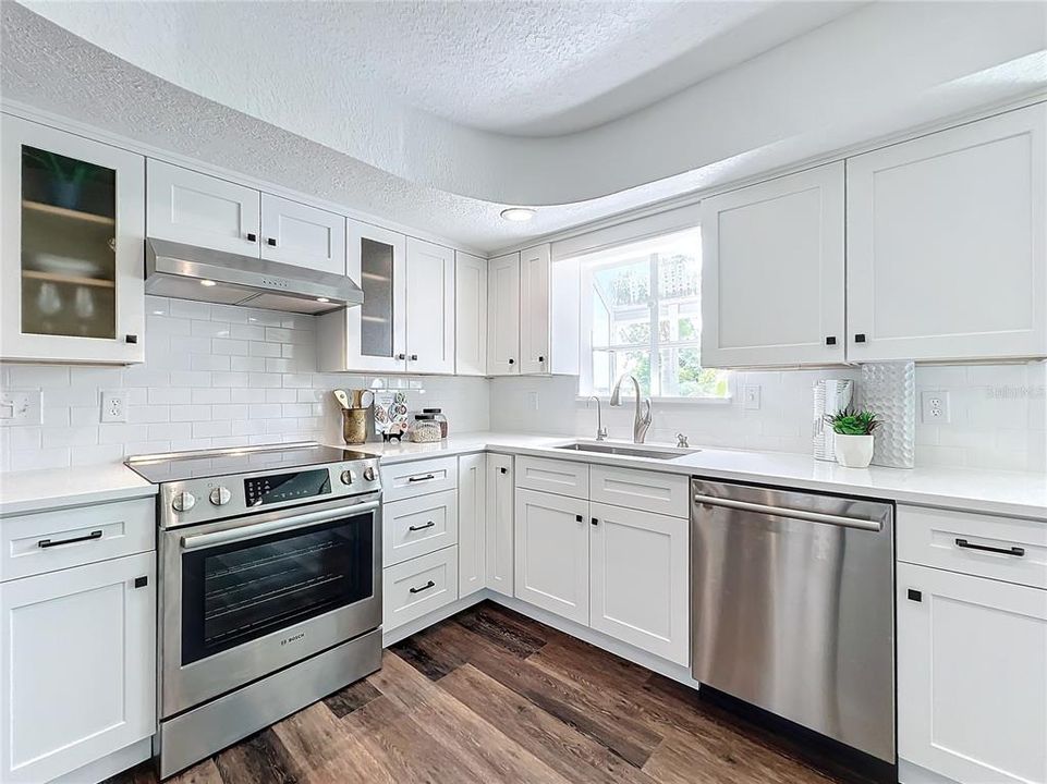 Window seat with storage, built in cabinetry and  custom shelving in the kitchen with a view of the canal.