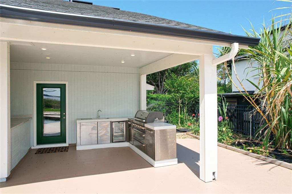 Prepare meals by the pool in the outdoor kitchen.