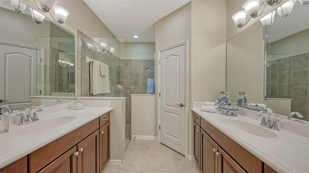 Primary bath has 2 separate vanities, large mirrors.