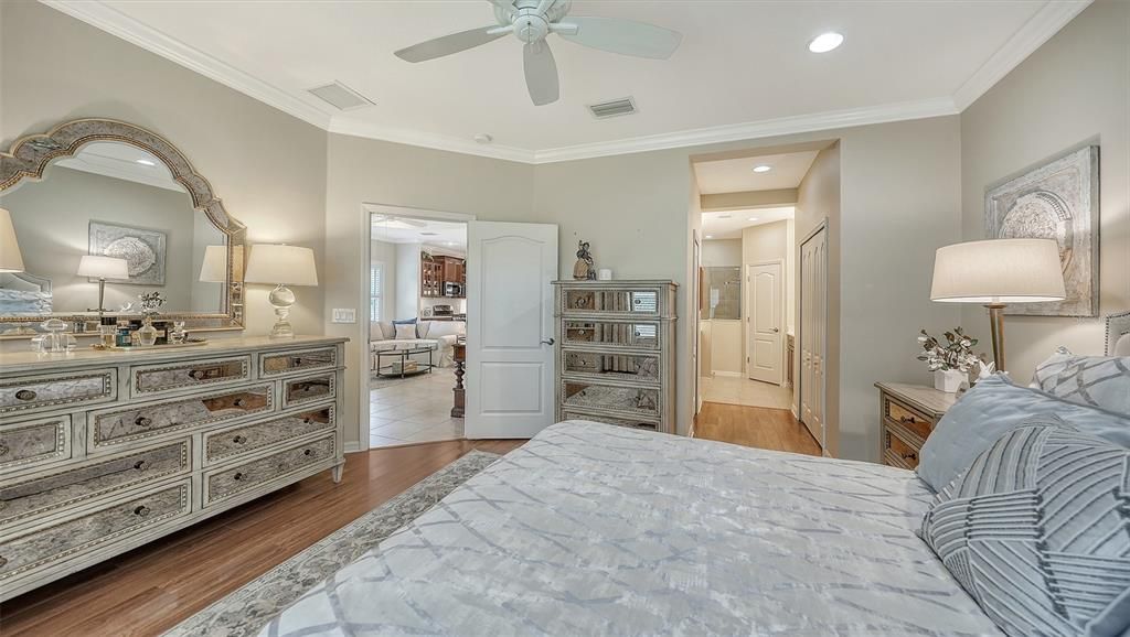 Recessed lighting and ceiling fan in primary bedroom.