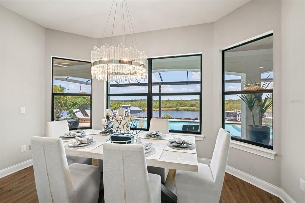 Dining space with a view of the pool and water