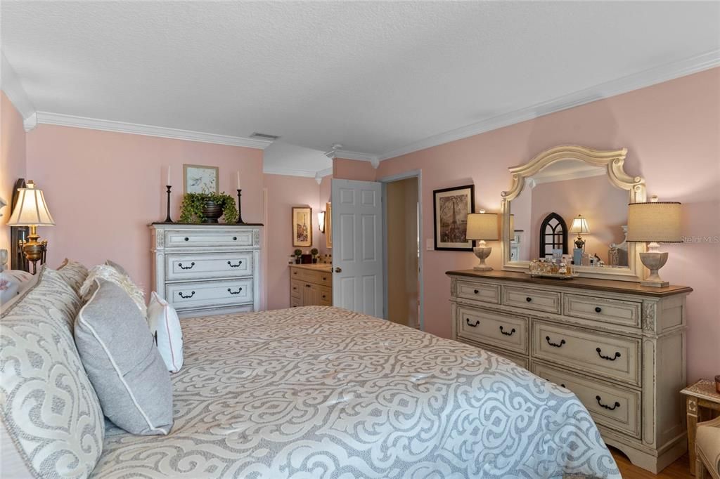 Primary Bedroom with crown molding and ensuite