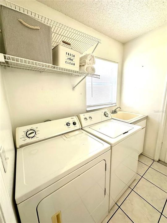inside full laundry room with sink