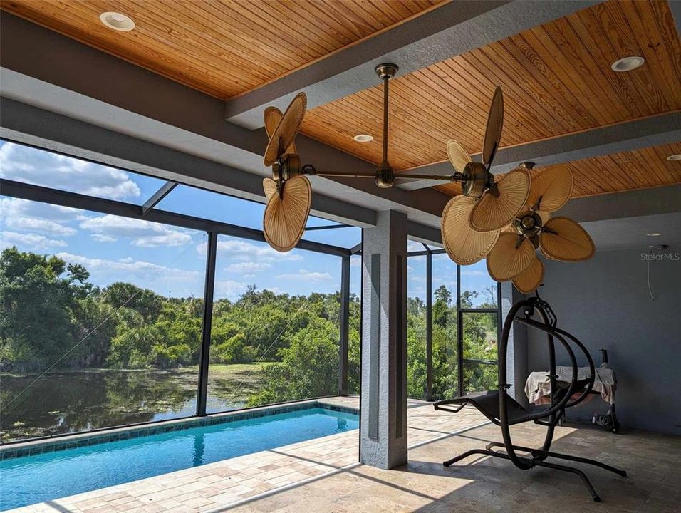 Large covered patio area with two fans