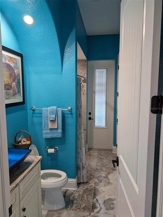 Guest bathroom with pool entryway