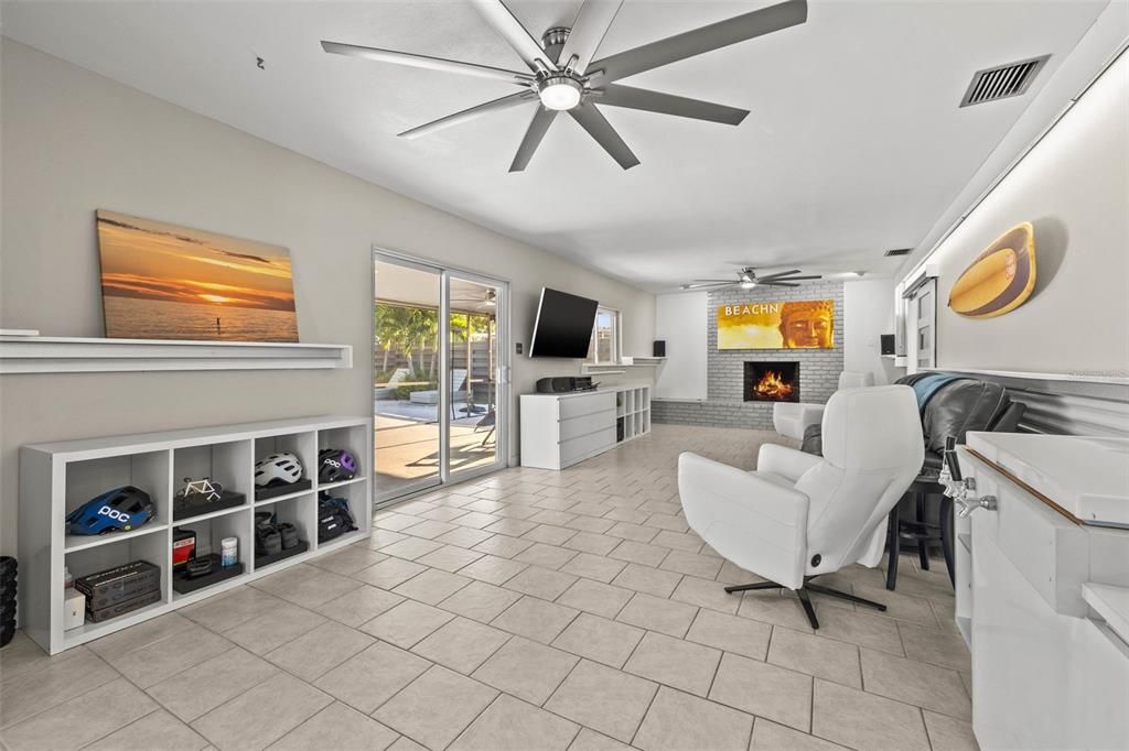Family room with fireplace and sliders that open to your screened in outdoor living room