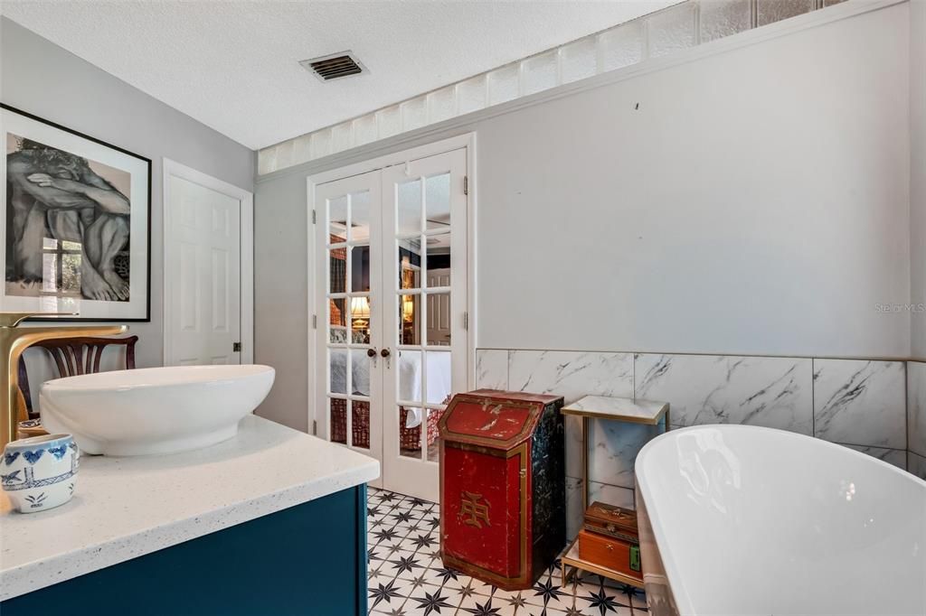 Differing tiles layer the color and texture on the floor and tub surround.