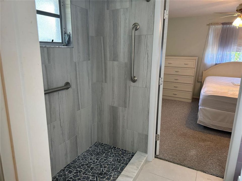 Main bath centered between the two other bedrooms. Remodeled shower.