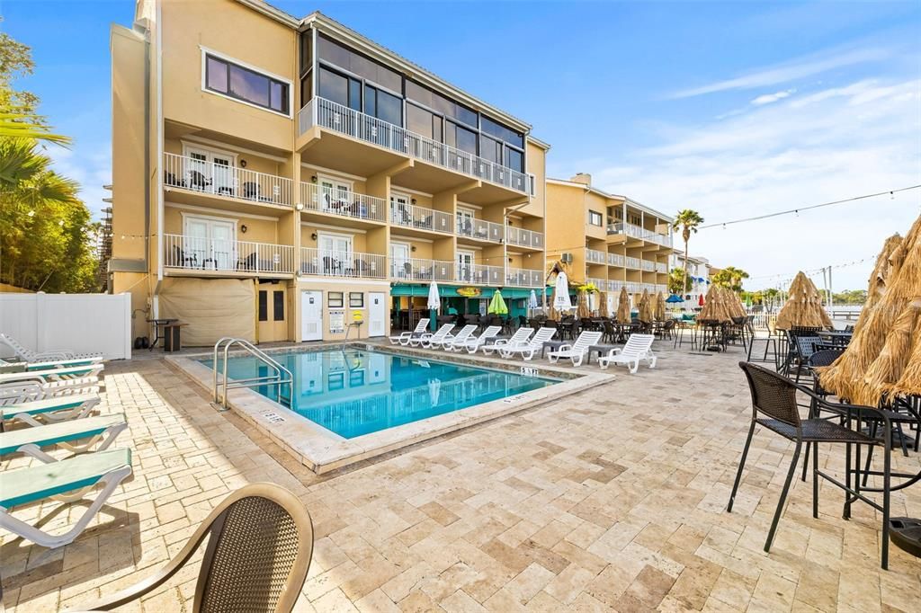 Pool deck includes two heated saltwater pools for resident use. Outdoor shower and grill available as well.