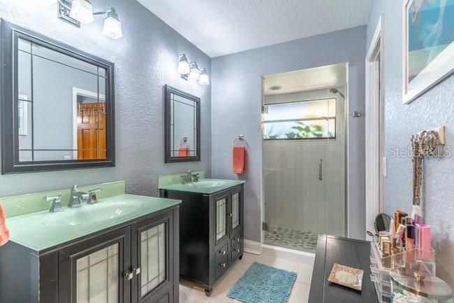Complete Remodeled Primary Bath, sep. vanities and a beautiful walk-in shower.