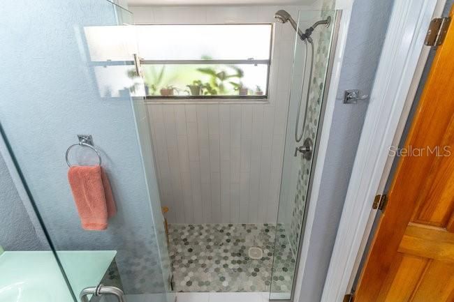 Tile in the primary shower to compliment the vanities