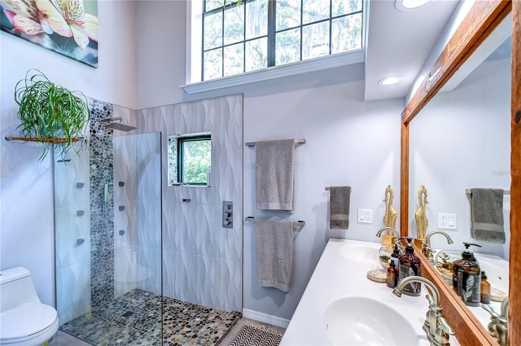 River rock walk-in shower with multiple shower heads!