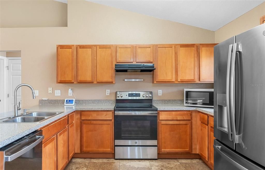 Kitchen equipped with stainless steel appliances and plenty of counter space.