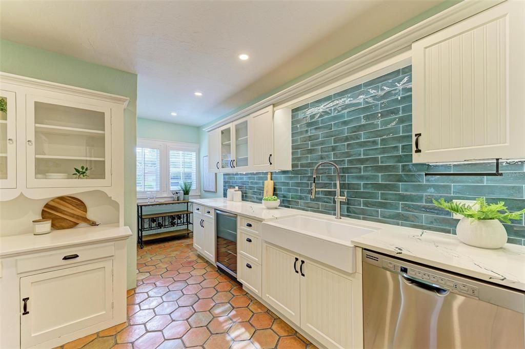 Kitchen renovation includes quartz counter tops, new cabinets ,custom back splash and farmhouse sink.