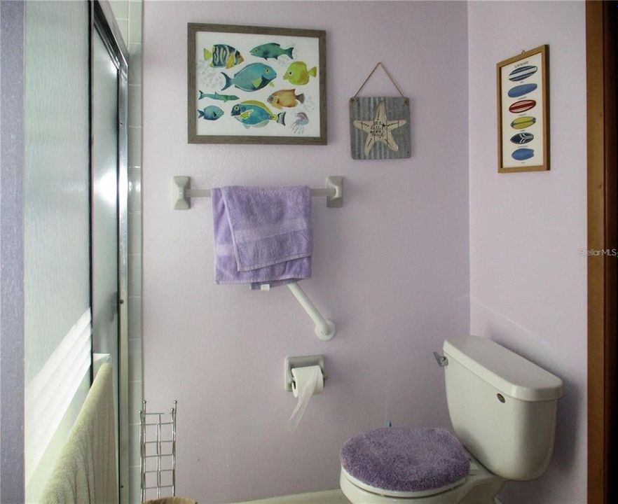 Commode and tiled shower in Jack N Jill bath