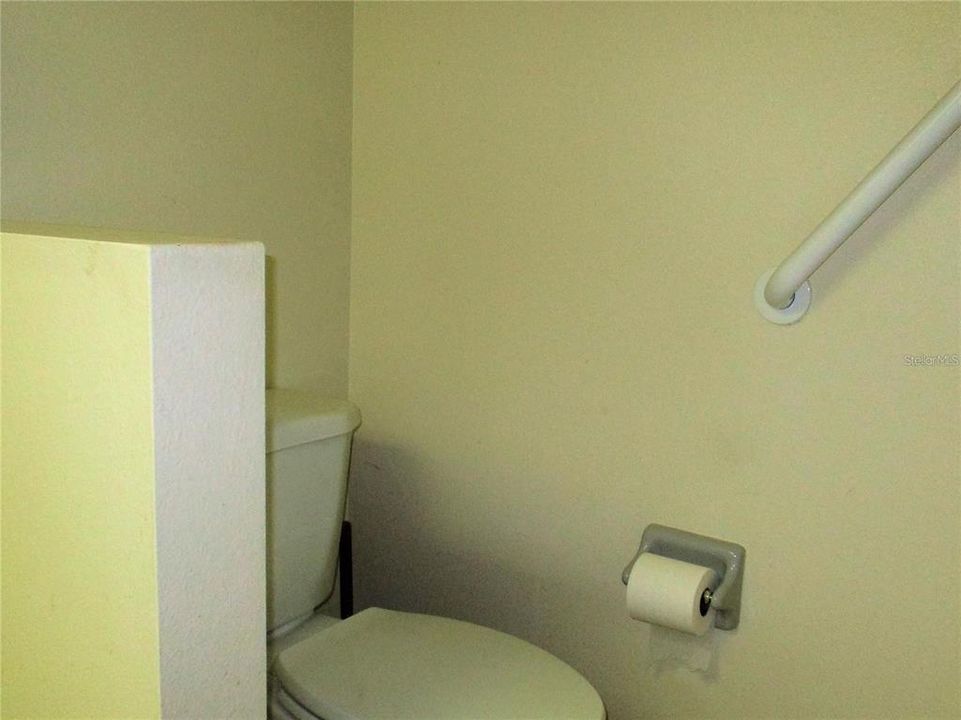 Commode with grab bar