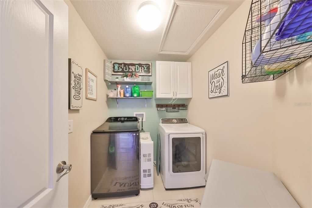 Laundry room with custom shelves and cabinet