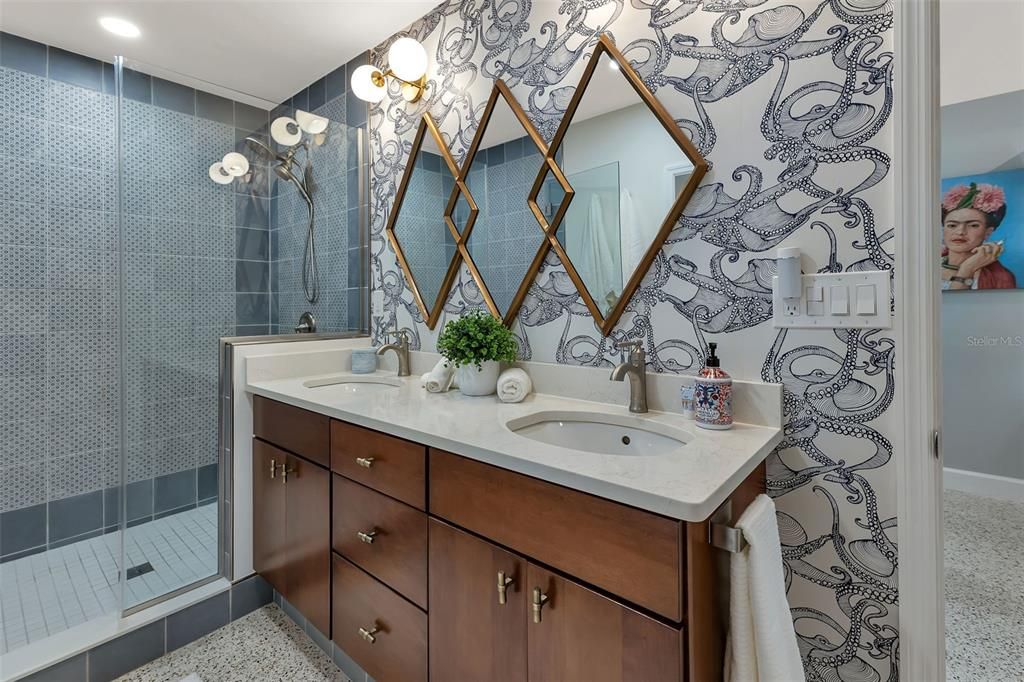 NEW PRIMARY BATH, DUAL SINKS, QUARTZ TOP, ROSE GOLD FIXTURES, AND LUXURIOUS SPACIOUS SHOWERWITH "VINTAGE OCEAN BLUE TILE"  A TOUCH OF WHIMSY ON THE WALLS, POLISHED TERRAZZO FLOORING