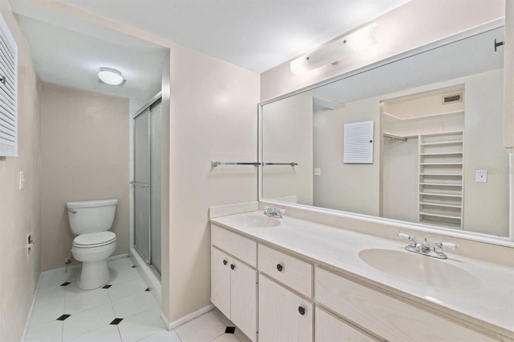 Owners ensuite bathroom featuring dual sinks, and a glass enclosed walk-in shower.