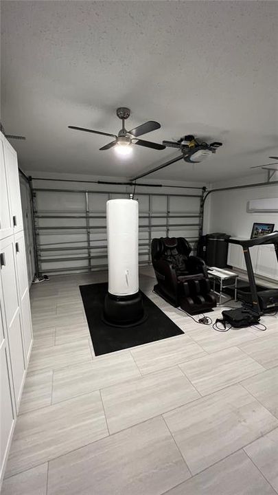 Garage - Tiled, AC and cabinetry