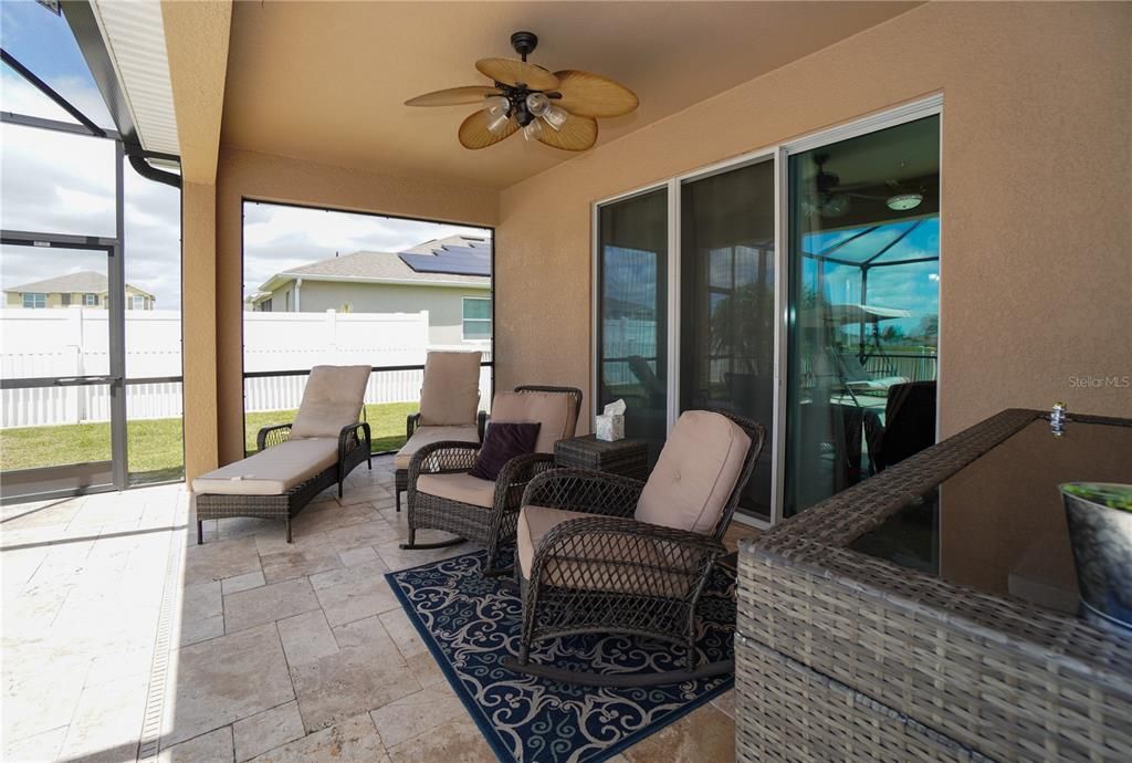 The covered patio is conveniently located right outside of the main living area with sliders from the great room.