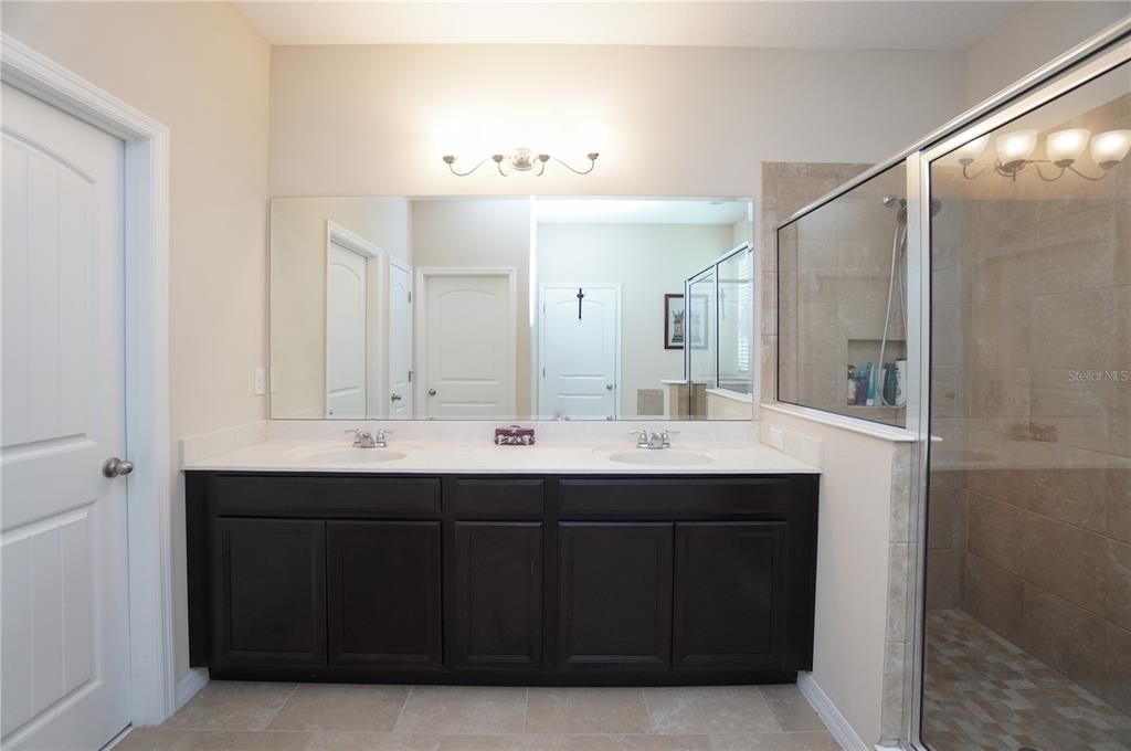 No need to fight over the sink in this master bathroom that has dual vanities and ample counter space.  Walk-in closet conveniently located within the master bathroom next to the vanity.