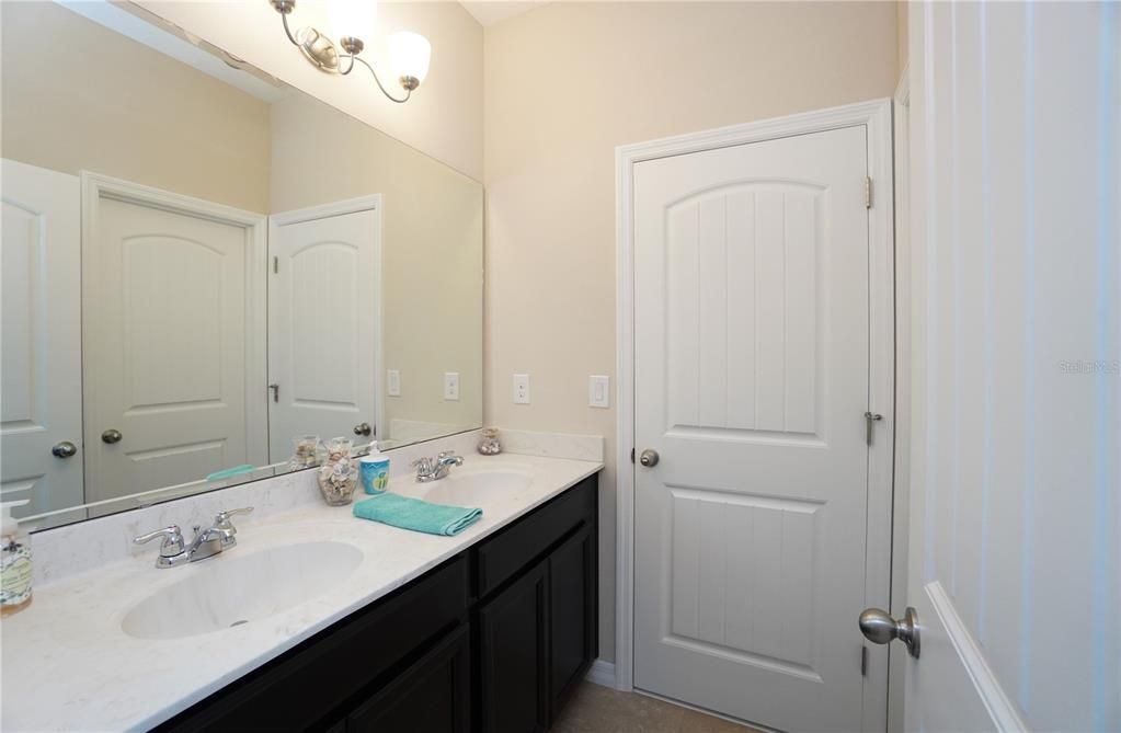 The jack-and-jill bathroom between the two front bedrooms is separated with a wall so one person can enjoy a private shower while another brushes their teeth.