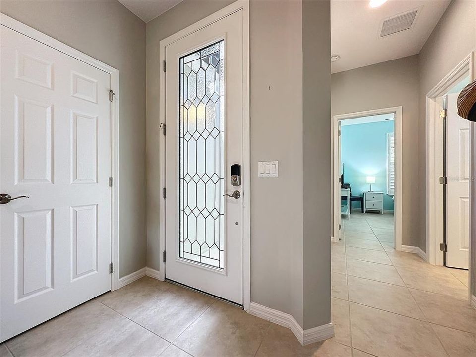 Foyer with dual closets and view to guest bedroom and bathroom