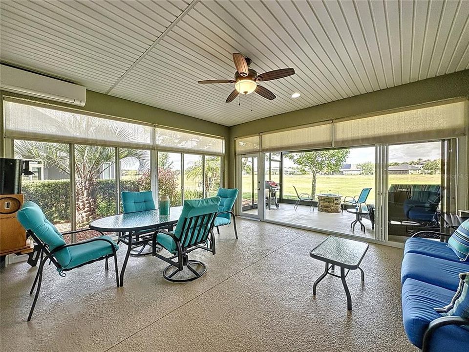 Enclosed air conditioned and heated lanai with oversized glass windows and shades