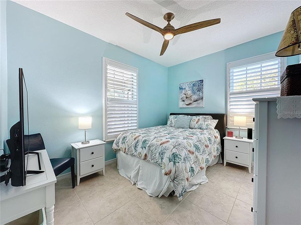 Guest bedroom is just steps from a full bathroom with oversized tub.