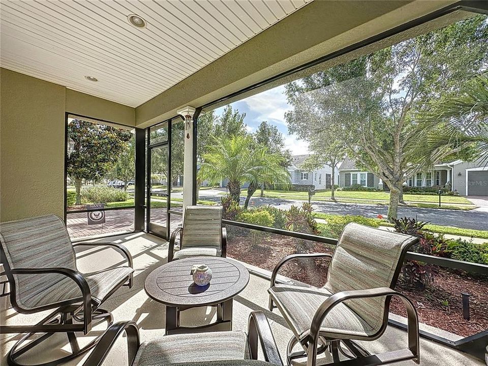 Screened front porch is ideal for enjoying the Florida breezes