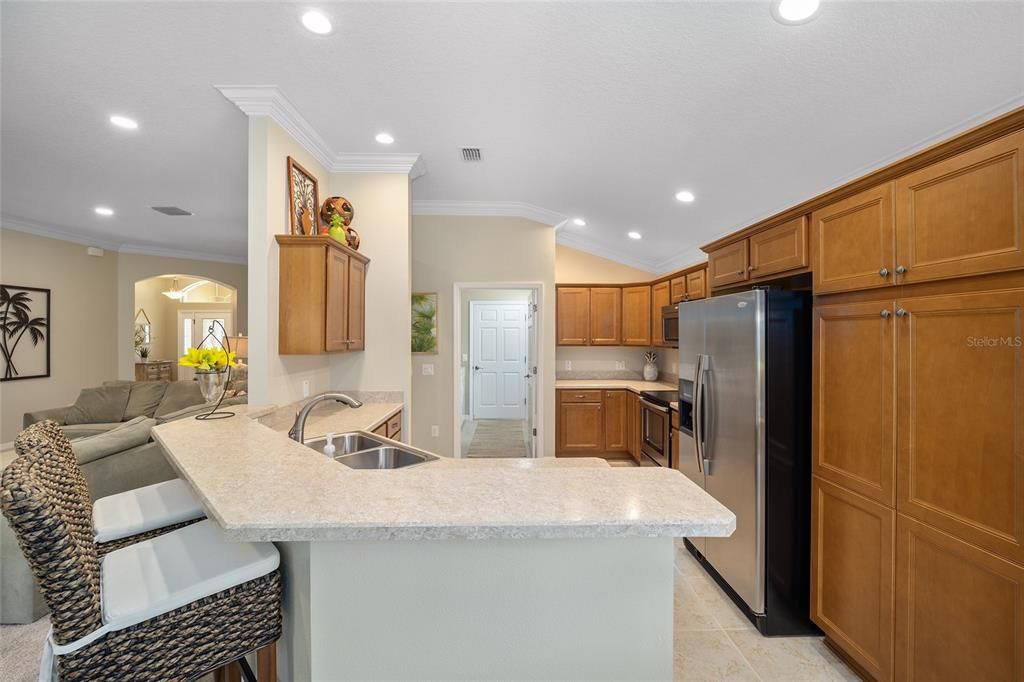 The kitchen with crown molding, high definition Formica and stainless appliances.