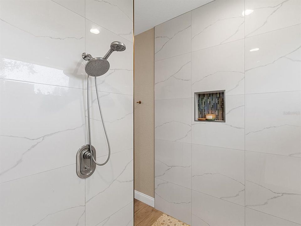 Walk in shower with dual shower heads.