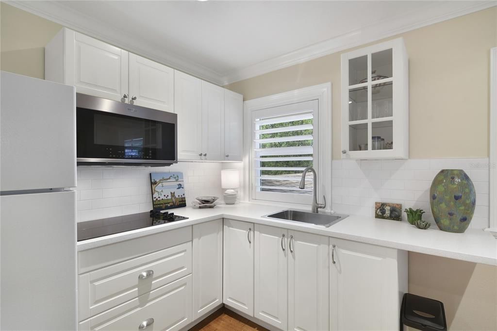 Second-floor bonus room with sink, microwave, refrigerator, and cooktop. Ideal in-law suite