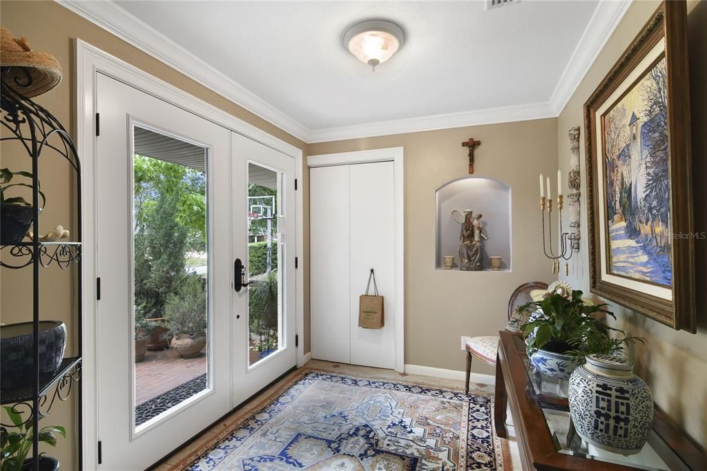 Elegant light-filled foyer with french doors