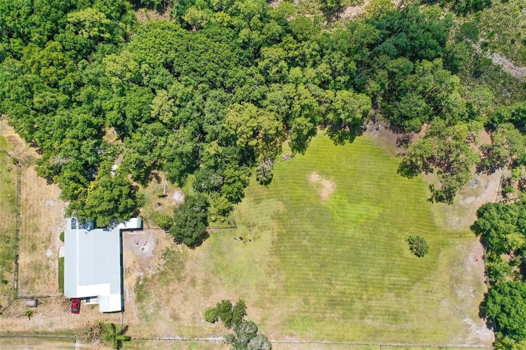 Aerial view of the barn and pasture behind the barn.